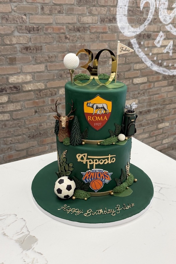 Green two-tier 30th birthday cake with golf, soccer, Knicks basketball, AS Roma, deer and gold number 30.