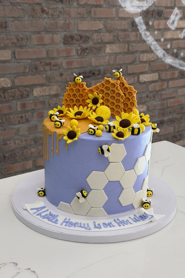 Honey bee cake with handcrafted bees, honeycomb, sunflowers and dripping honey.