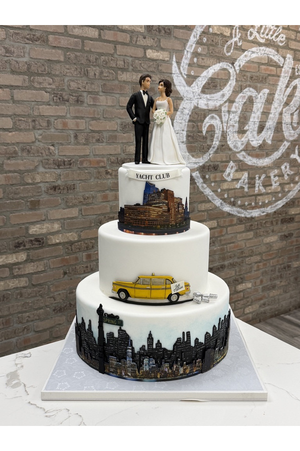 Three-tier New York City wedding cake with Manhattan skyline, yellow taxi, Yacht Club scene and bride and groom topper.