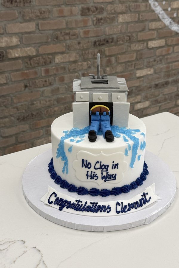 Plumber retirement cake plumber figure and water details.