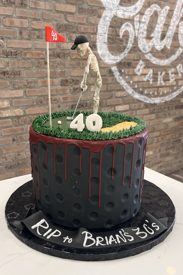 40th birthday golf cake with sculpted skeleton golfer, golf club, flag, golf ball and sand trap.