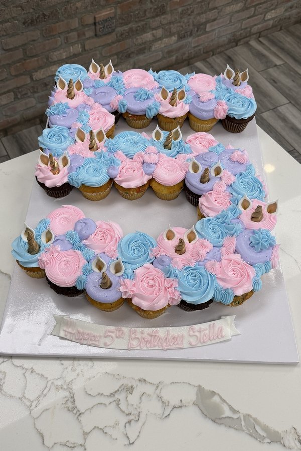Number 5 unicorn pull-apart cupcake cake with buttercream rosettes, unicorn horns and ears.